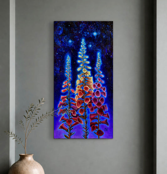 Painting of foxglove flowers against a starry night sky on a gray wall with a vase on a wooden surface in the foreground.