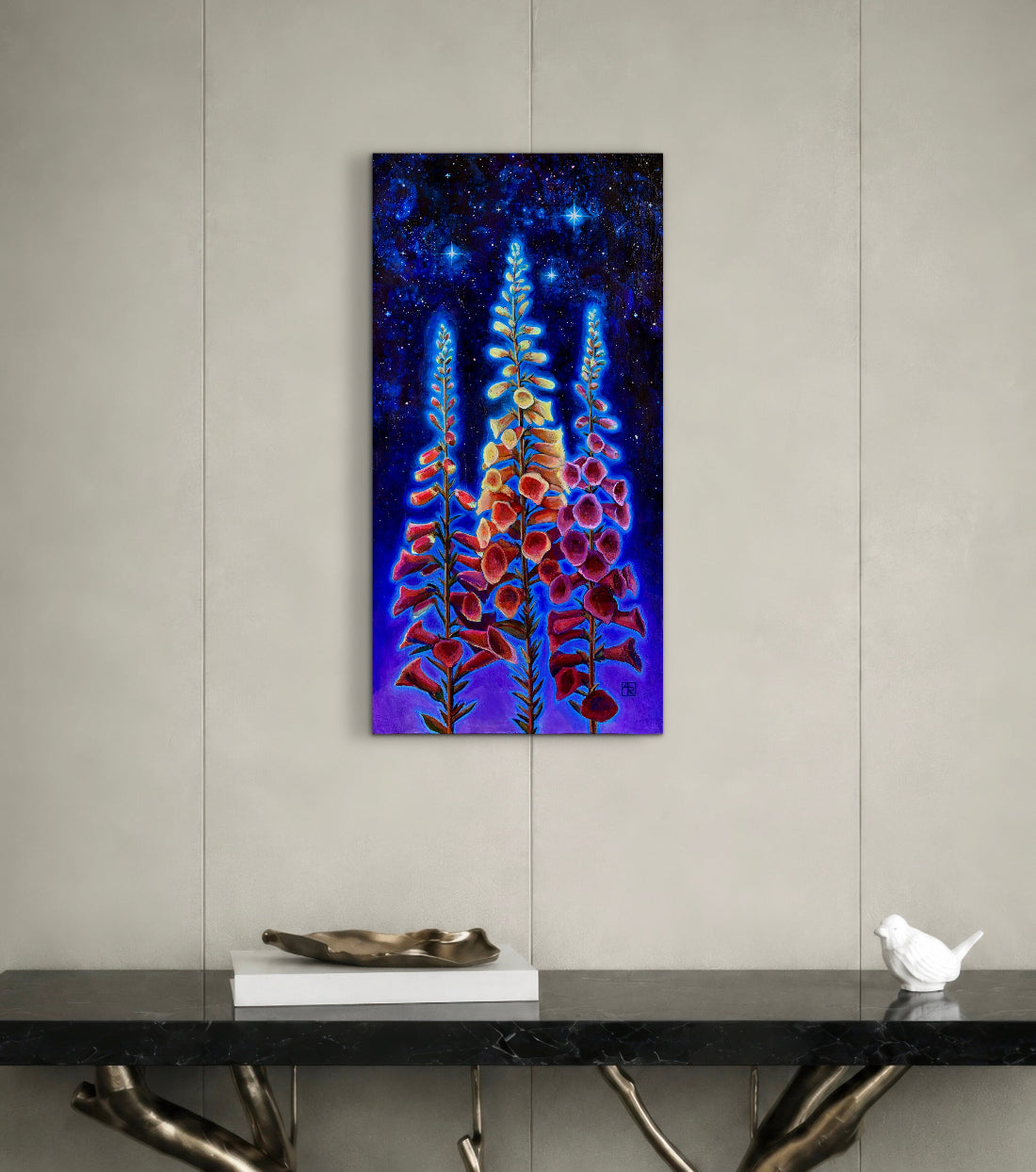 Colorful floral painting on a wall above a black console table with decorative items.
