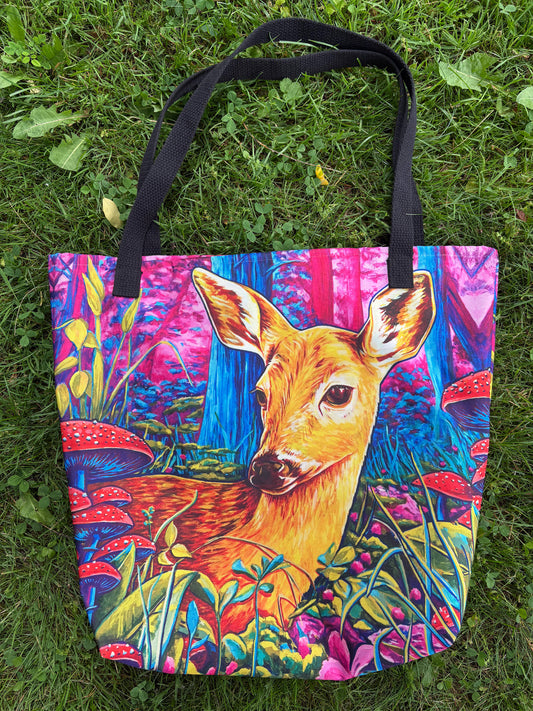 Tote bag with a deer design on a grassy background
